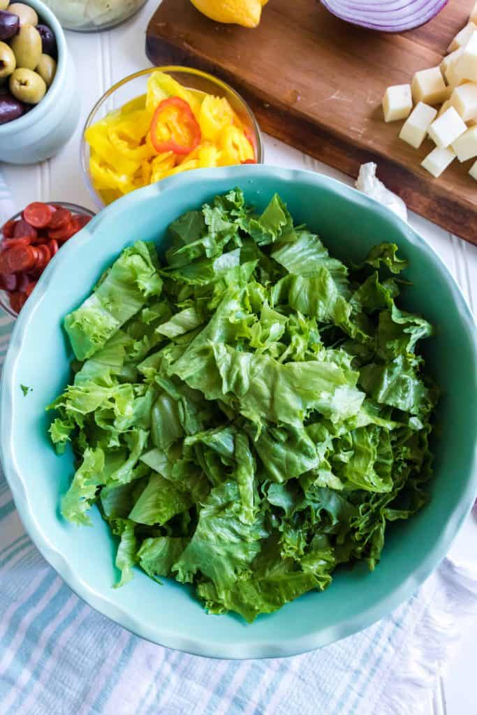 Salad greens in blue bowl.