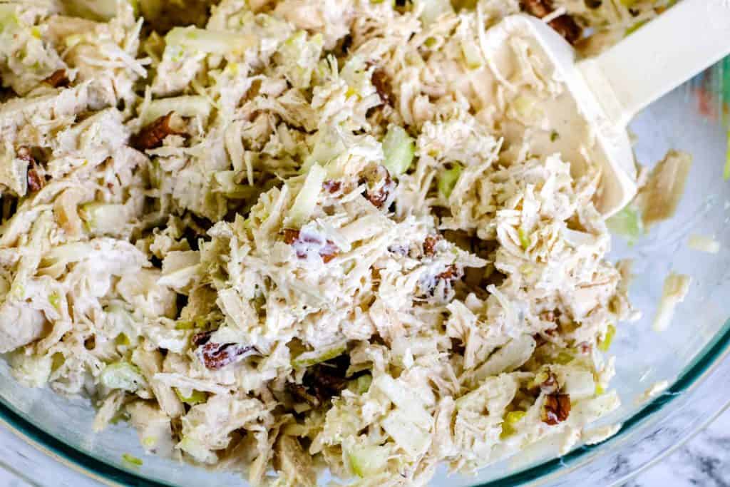 Closeup of chicken salad in a glass bowl.