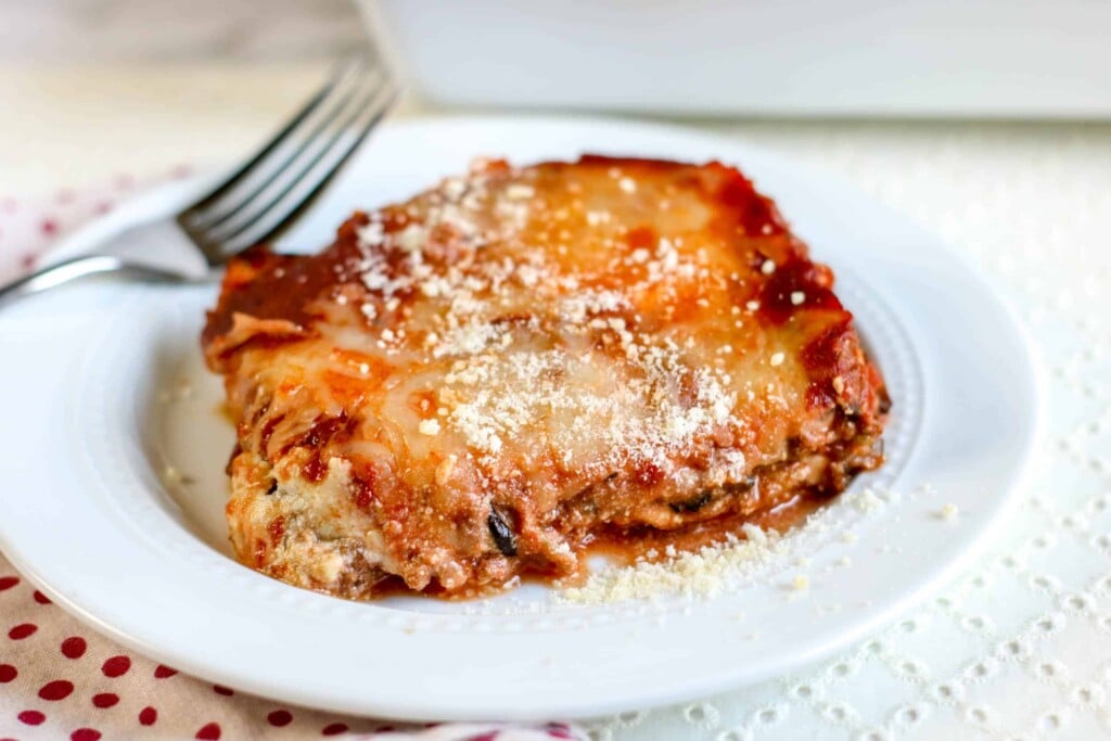 Keto Eggplant Lasagna on a white plate with a fork on the side.
