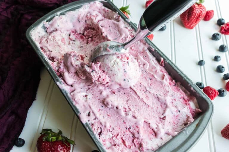 Triple Berry Ice cream with ice cream scoop in it.
