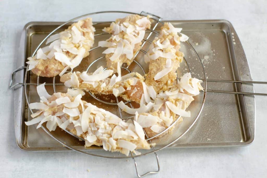 Keto chicken tenders on a rack on a baking sheet.