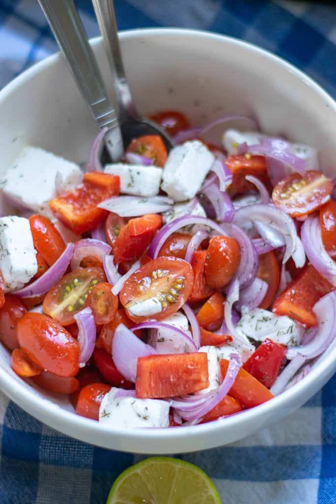 Mediterranean Tomato Salad in a white bowl.