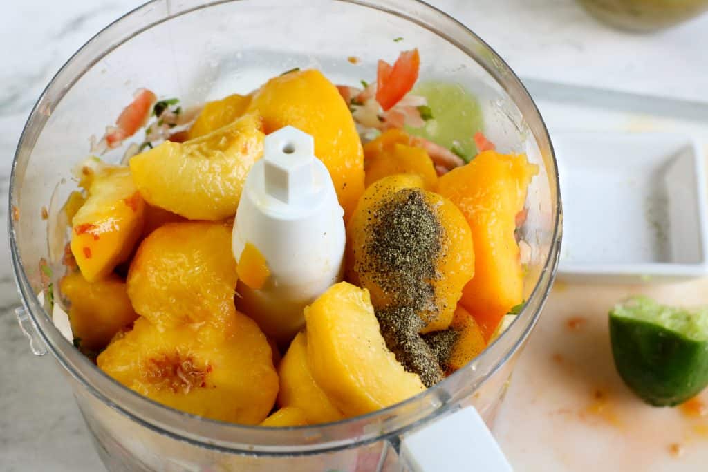 Peaches and spices in a food processor.