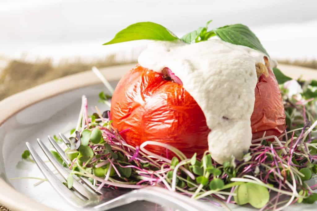 Tomatoes Stuffed with Rice and Cashew Cream Sauce on bed of micro greens.