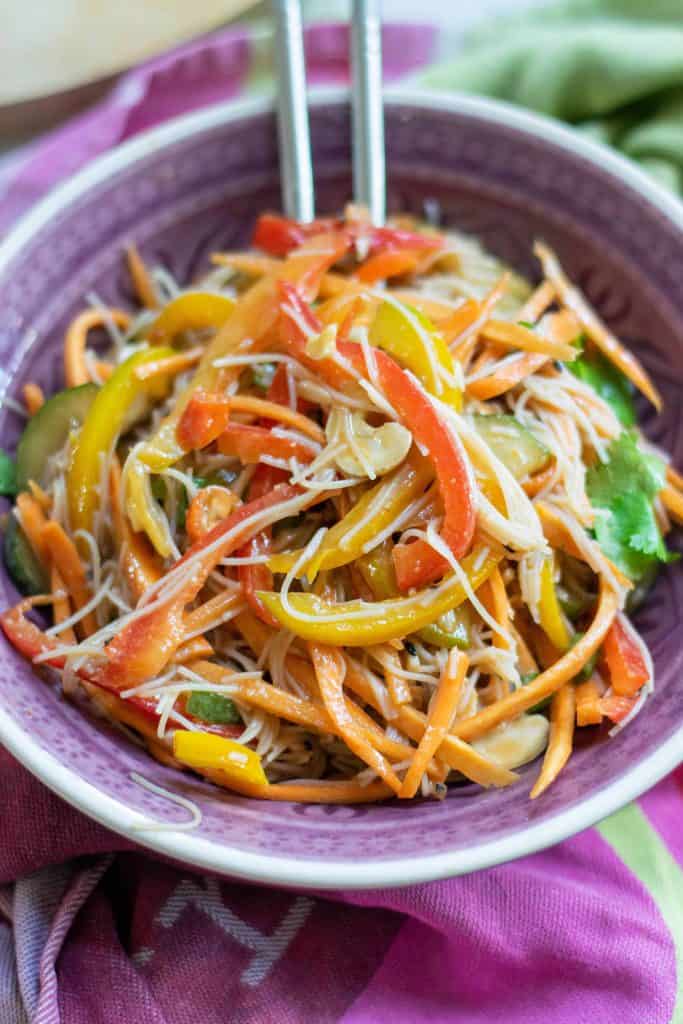 Easy to Make Thai Peanut Salad in a purple bowl with metal chopsticks.