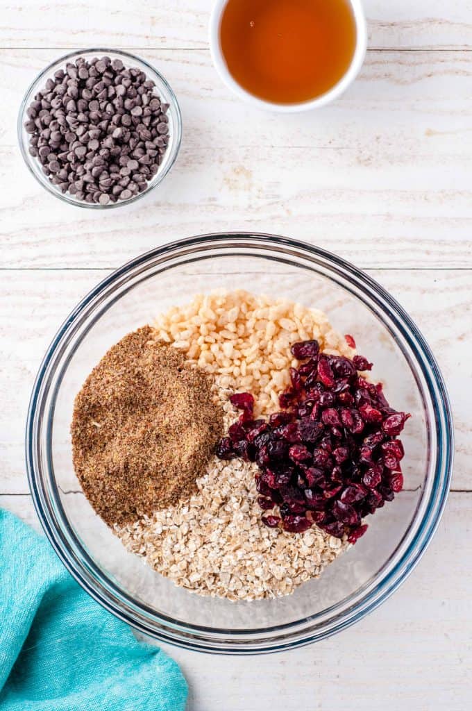 Glass bowl with oats, dried cranberries, chia seeds and nuts.