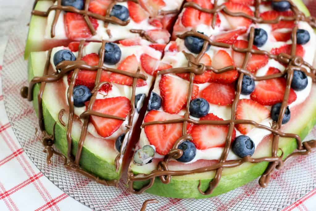 Angela shot of watermelon pizza with chocolate drizzle.