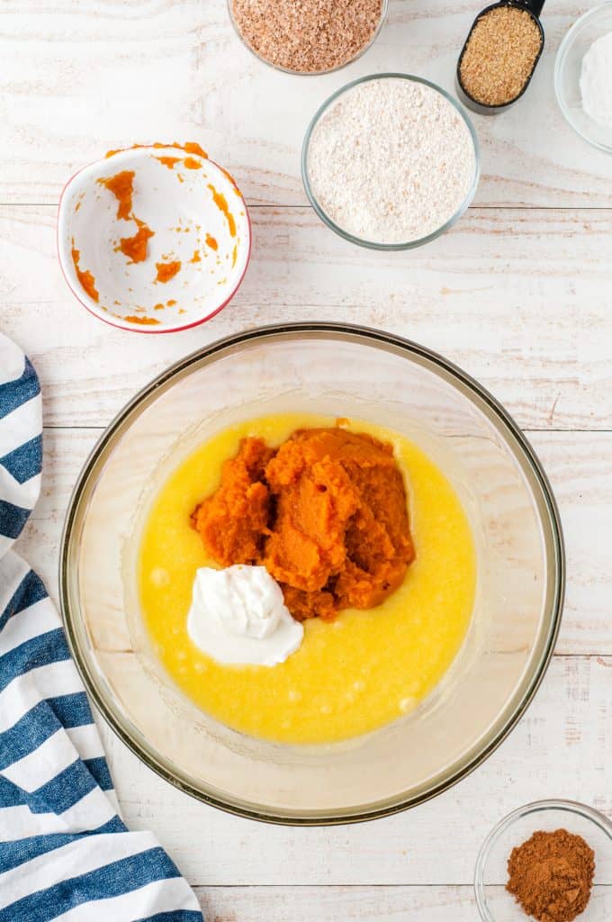 Pumpkin puree, melted powder and baking powder in a glass bowl.