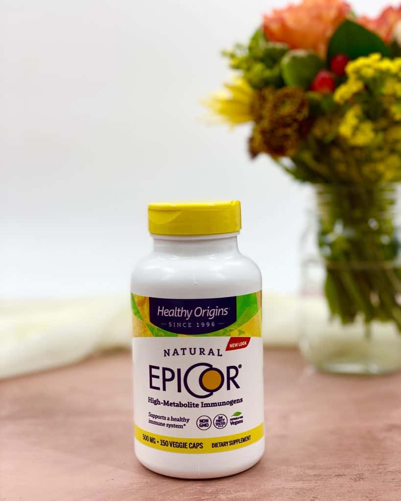 Epicor bottle with flowers behind it.