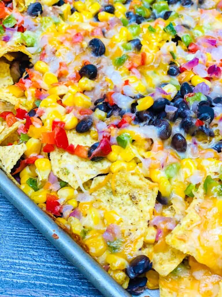 Closeup of melted cheese on vegetarian nachos.