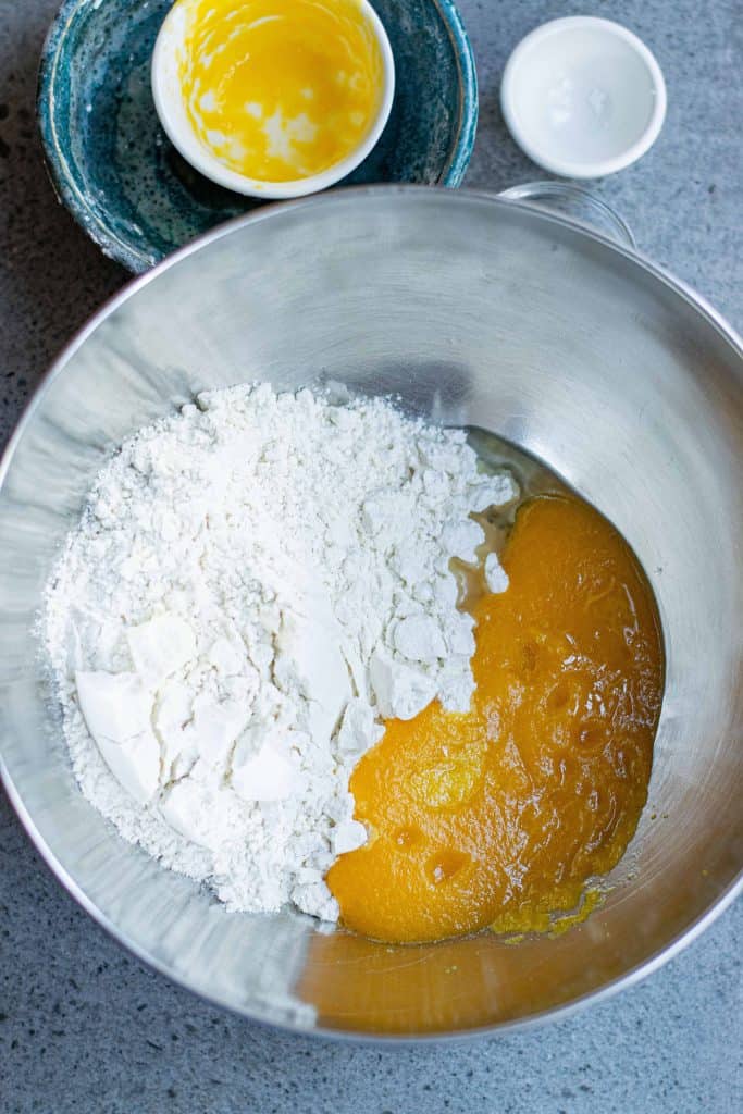 Flour and pumpkin purée in a stainless steel bowl.