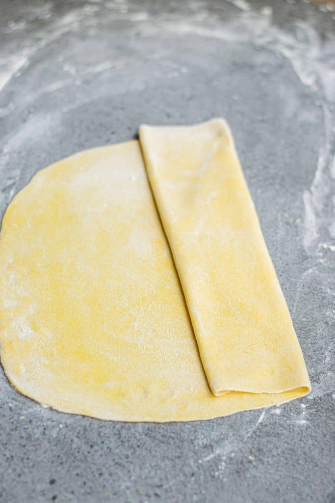 Folding pasta dough over.