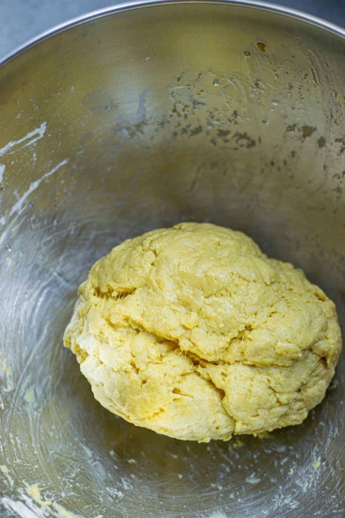 Pumpkin pasta dough in a stainless steel bowl.