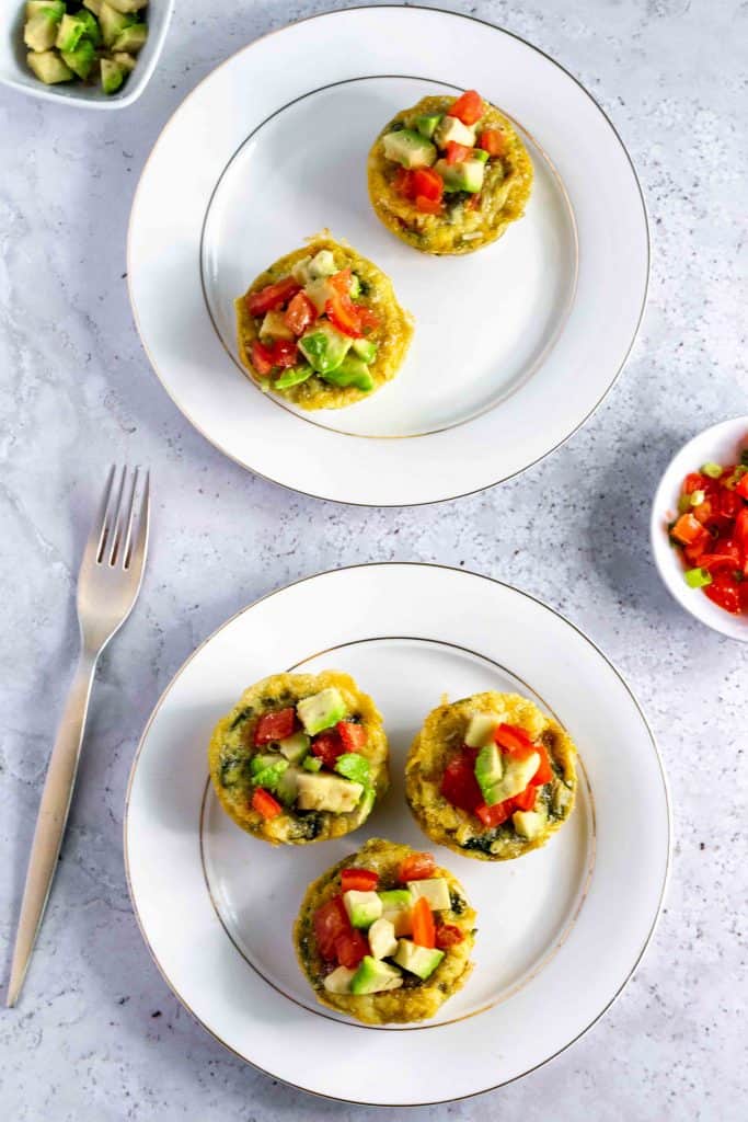 2 plates with keto egg muffins on them and a fork on the side.