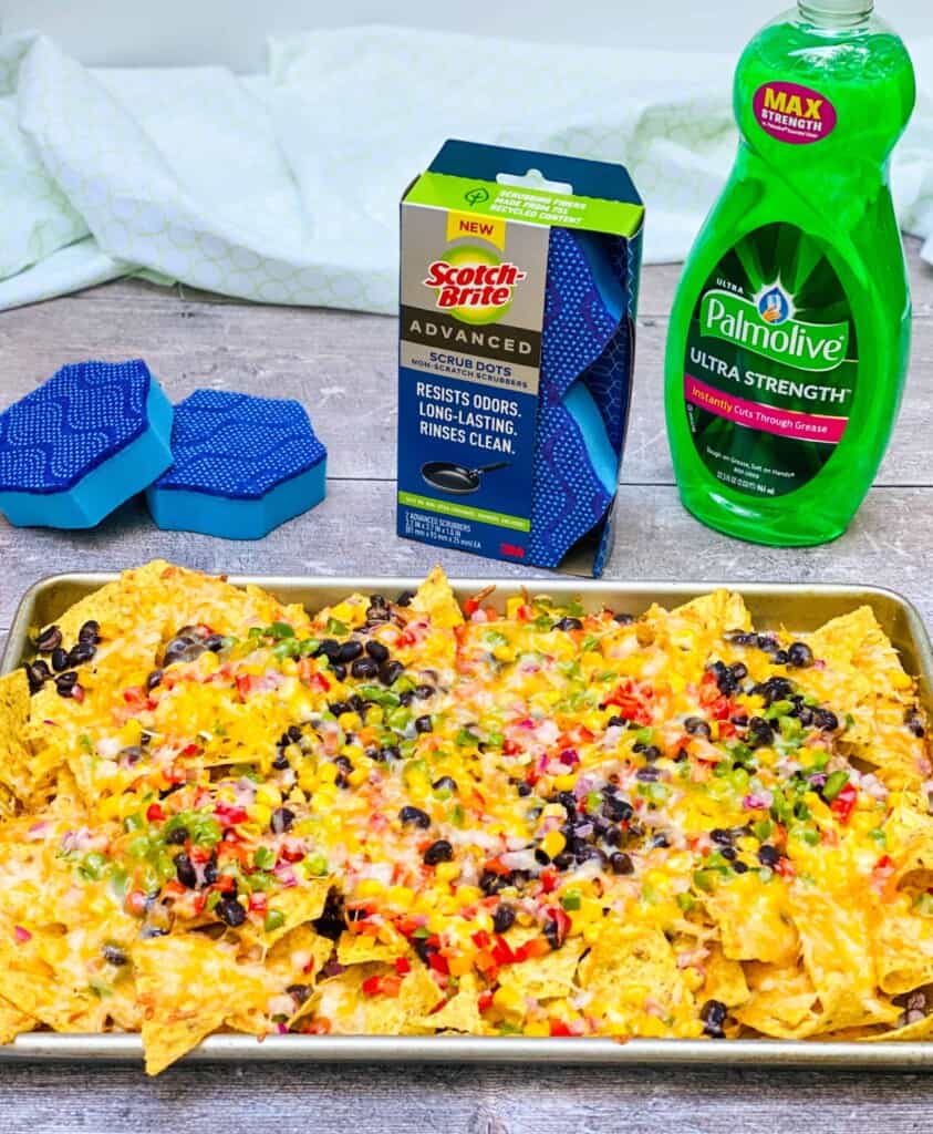 Angled photo of loaded vegetarian nachos with Scotch Brite Scrub Dots and Palmolive Dish Soap behind.