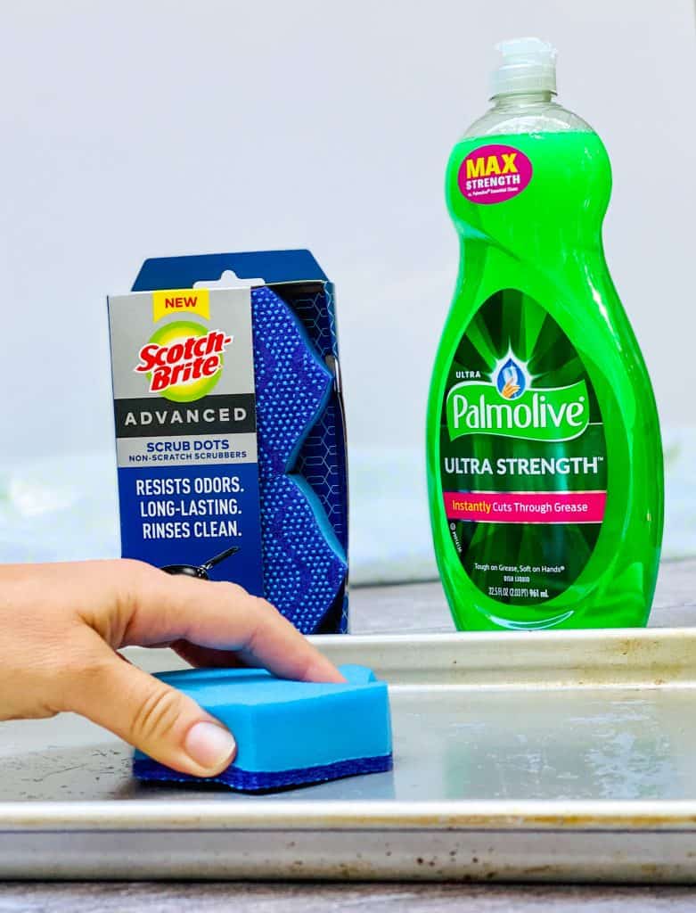 Scrubbing pan with Scotch Brite Advanced Scrub Dots and Palmolive Ultra Strength Dish Soap.