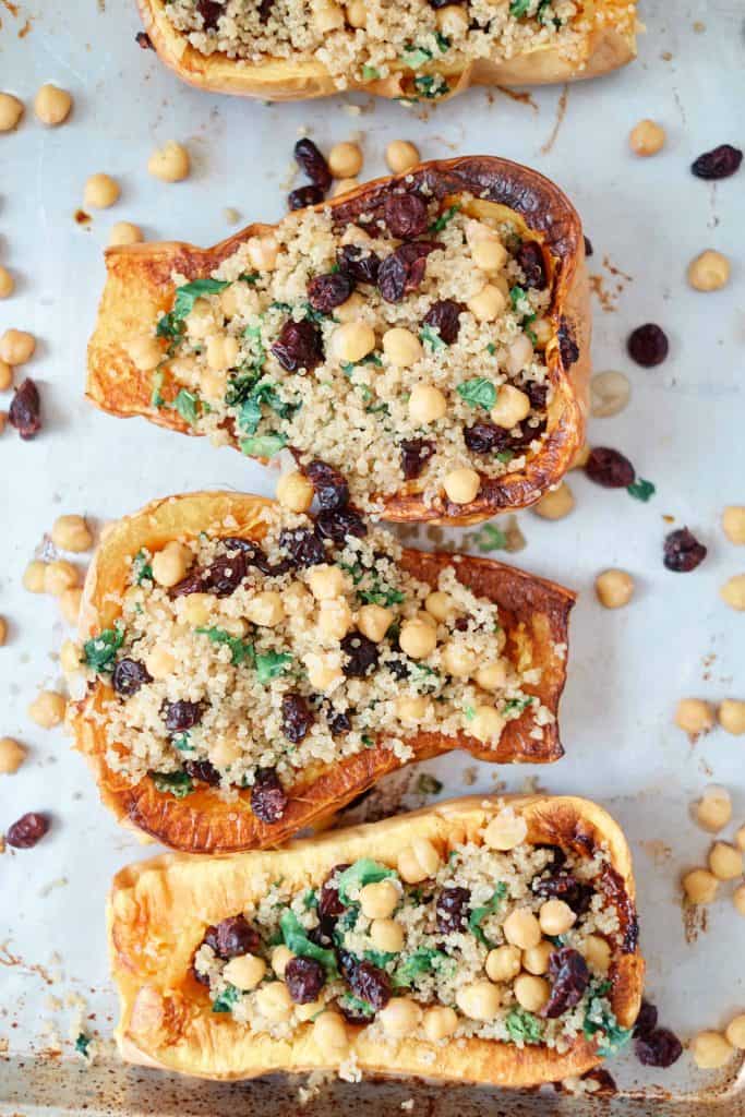 Overhead picture of vegan stuffed squash on a white counter top.