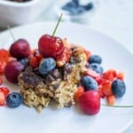 Vegan Baked Oatmeal with fruit on a white plate.