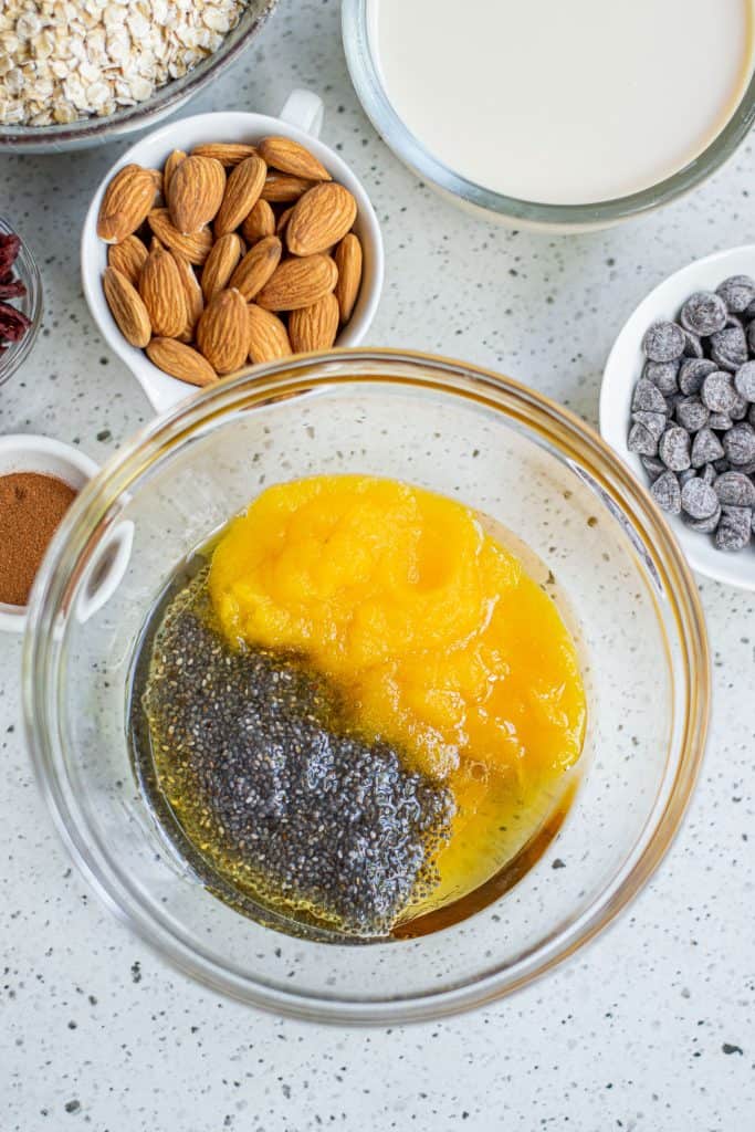 Chia seeds and pumpkin purée in a mixing bowl.