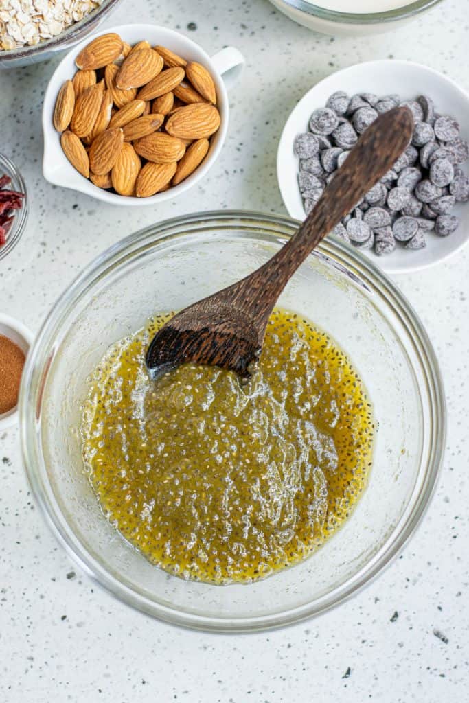 Chia seeds combined with pumpkin puree, agave syrup and oil in a mixing bowl.