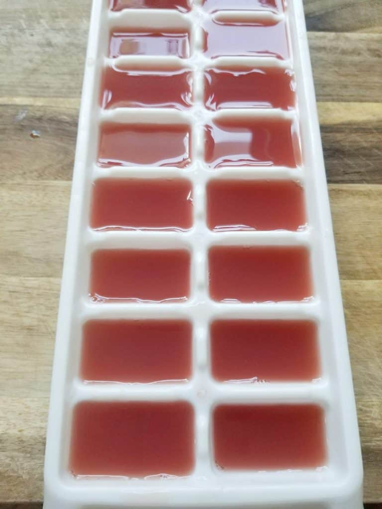 Cranberry juice in an ice cube tray.