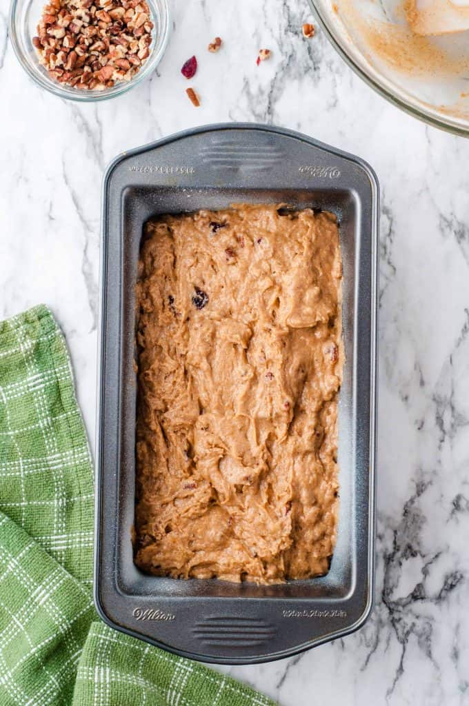 Cranberry Pumpkin Nut Bread Iin a loaf pan.