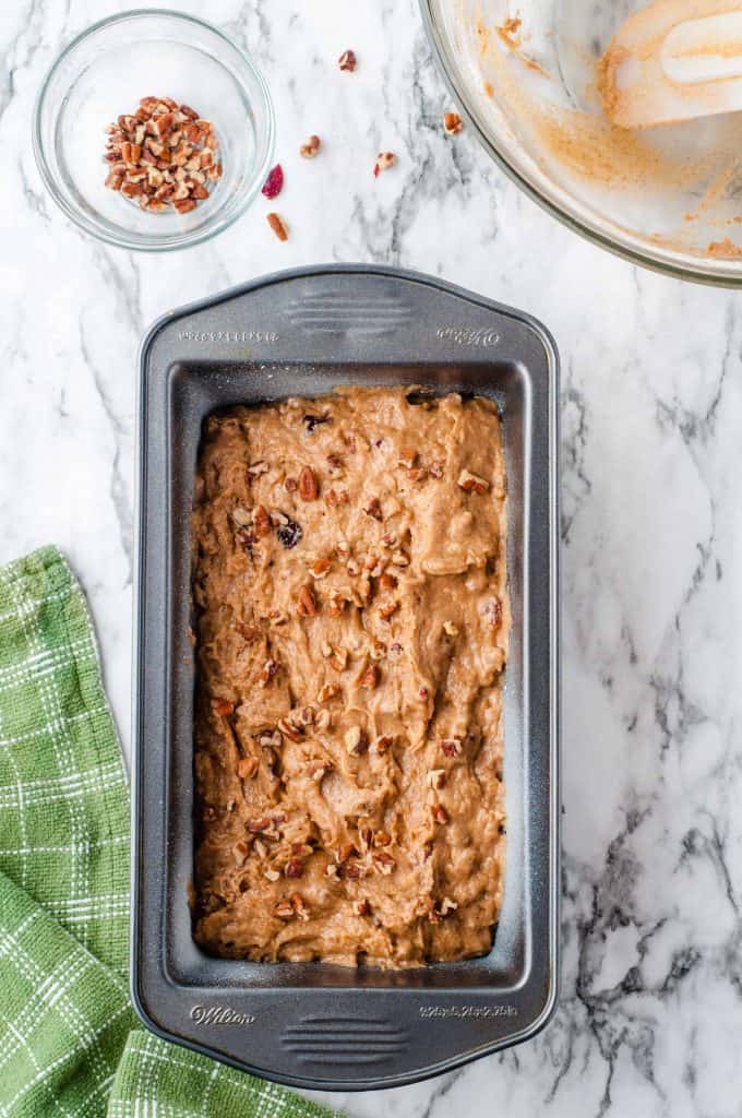 Cranberry Pumpkin Bread Batter with Nuts in a loaf pan.