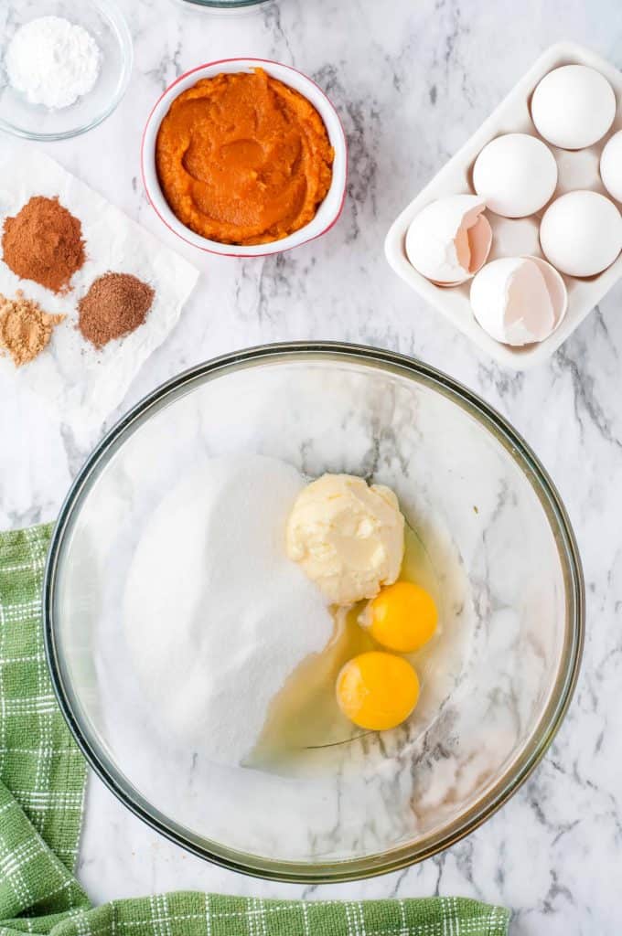 Eggs, butter, milk and flour in a bowl.