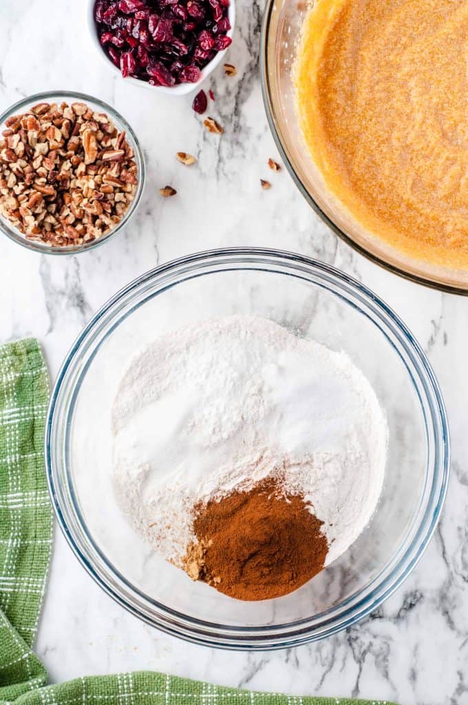 Flour, cinnamon, nutmeg in a medium glass bowl.