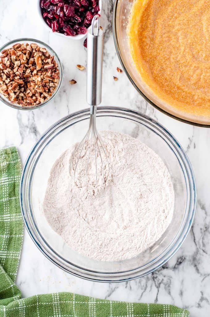 Dry ingredients whisked together in a glass bowl.
