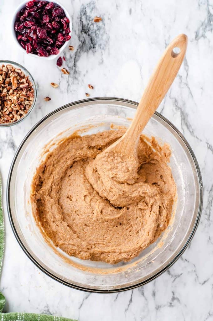 Wooden spoon in bread batter dough.
