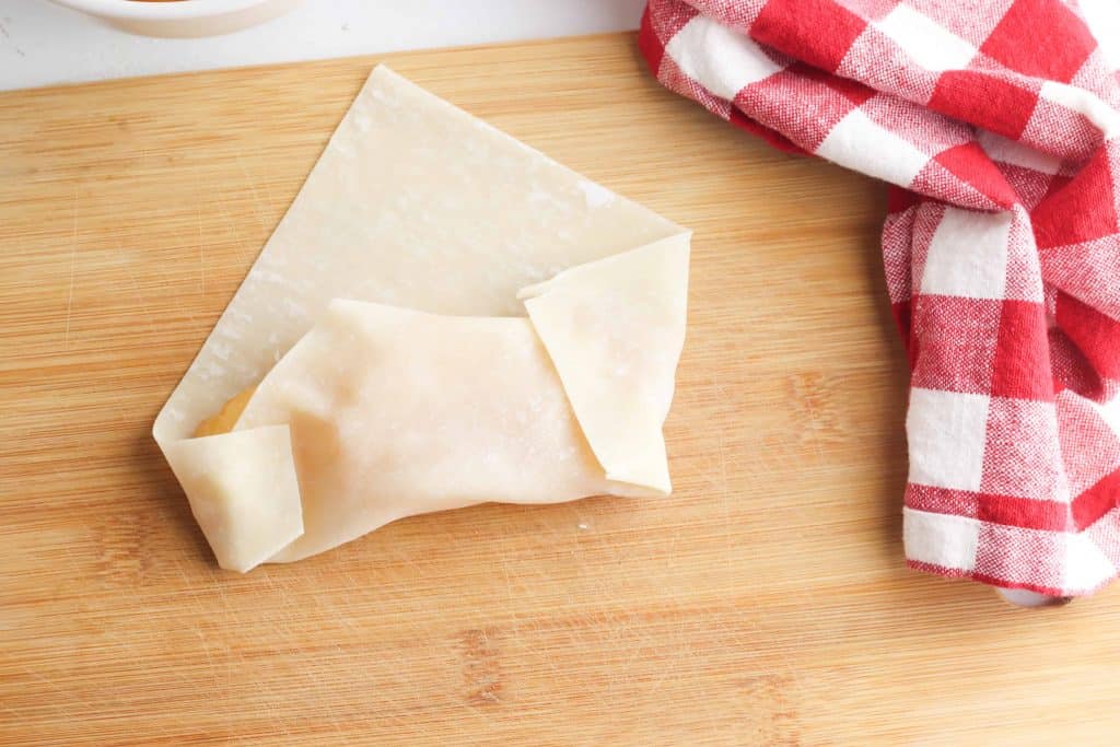 Egg roll being folded over.