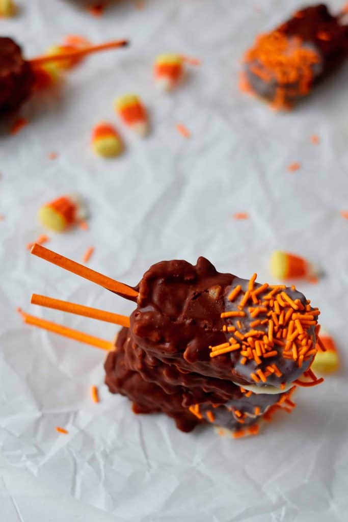 Stack of Halloween Rice Krispie Pops on a white background.