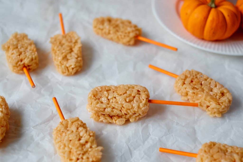 Rice Krispie pops on parchment paper.