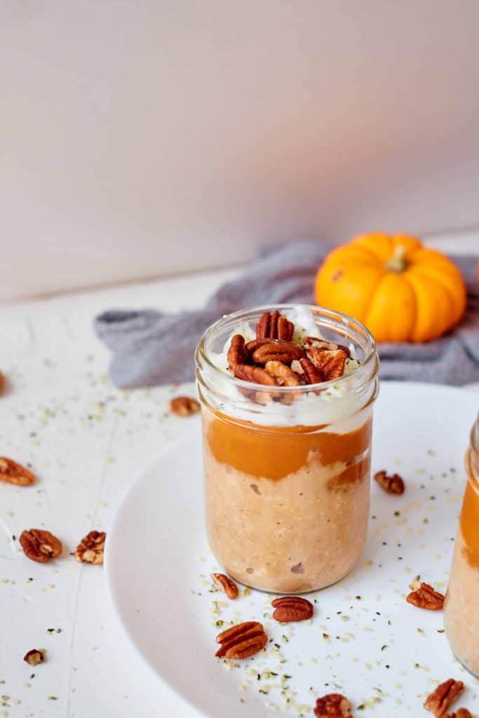 Pumpkin overnight Oats with a small pumpkin in the background.