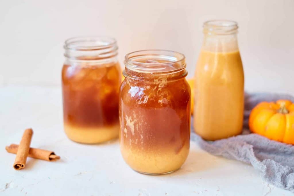 Iced Coffee with pumpkin spice creamer in a mason jar.