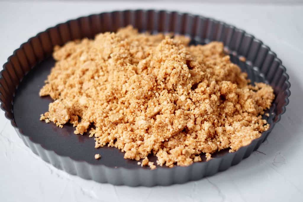 crumbled graham crackers in a tart pan.