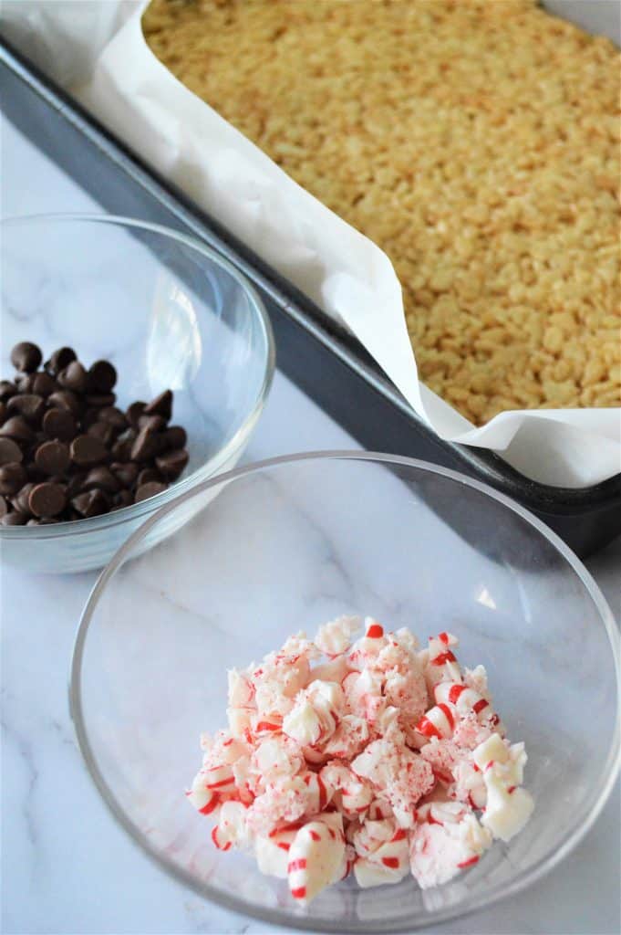 Rice Krispie treats in pan lined with parchment paper.