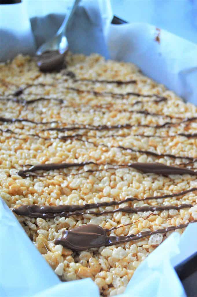 Rice Krispie bars drizzled with chocolate.