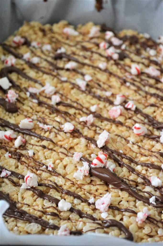 Crushed pepper mint candies on top of Rice Krispies.