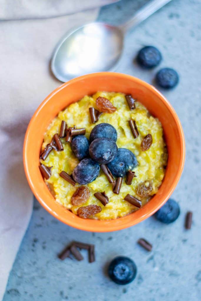 Overhead shot of oatmeal with a spoon above it.
