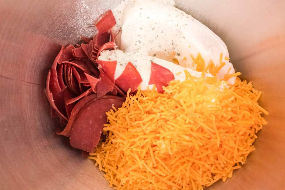 Cream cheese spread in a stand mixing bowl.