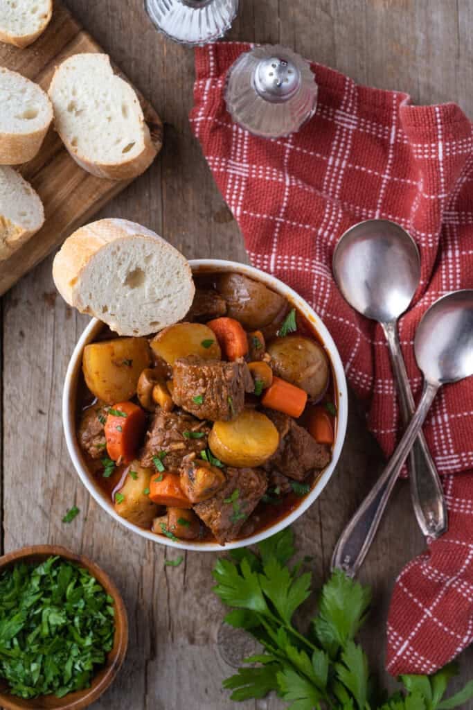 Overhead view of Dutch Oven Beef Stew with Crusty white bread.