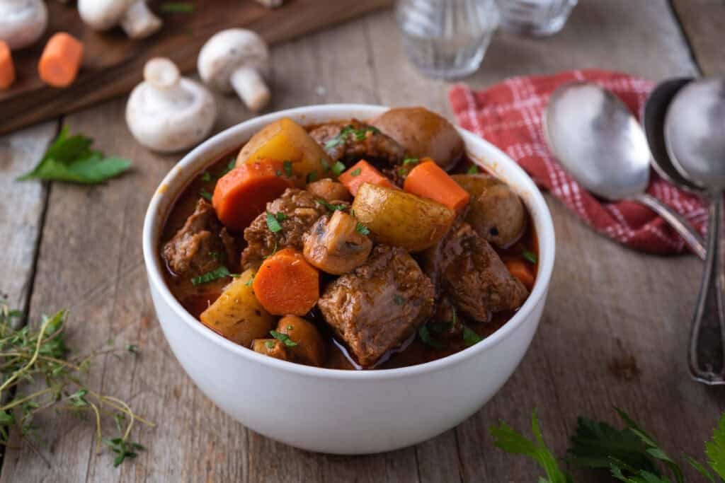 Beef stew in a white bowl.