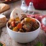 Dutch oven beef stew in a white soup bowl.
