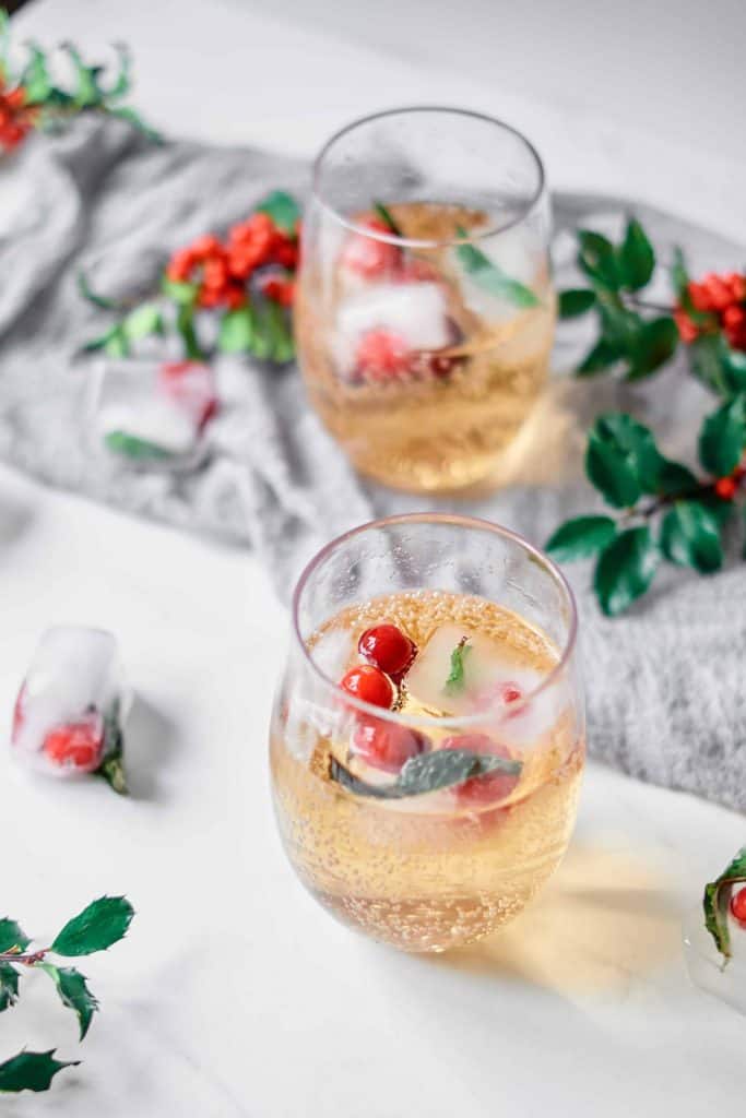 Festive ice cubes served in a small glass of ginger ale.