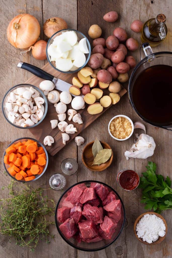 Overhead view of all ingredients to make a stew with beef and vegetables.