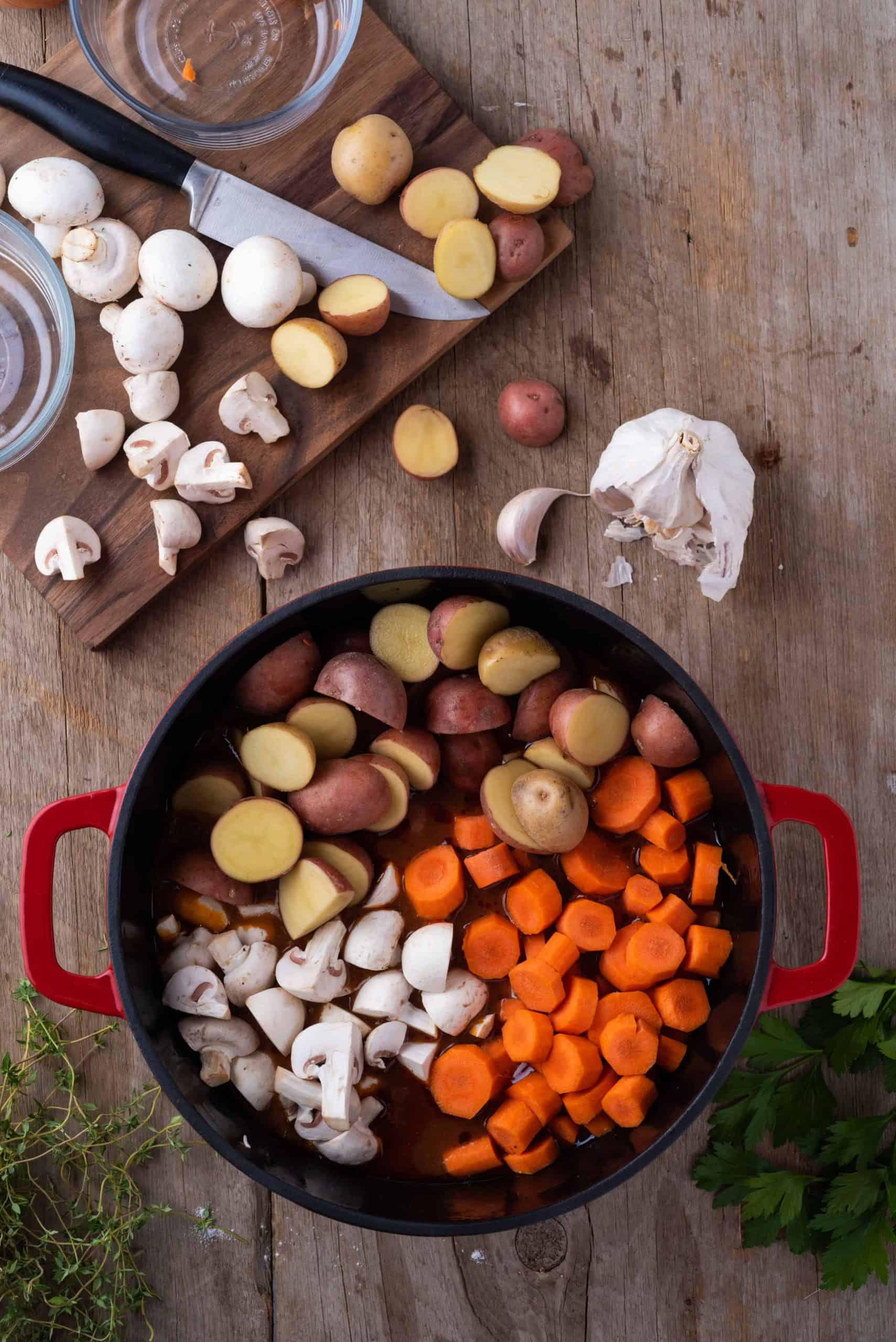 Carrots, mushrooms and potatoes in dutch oven.