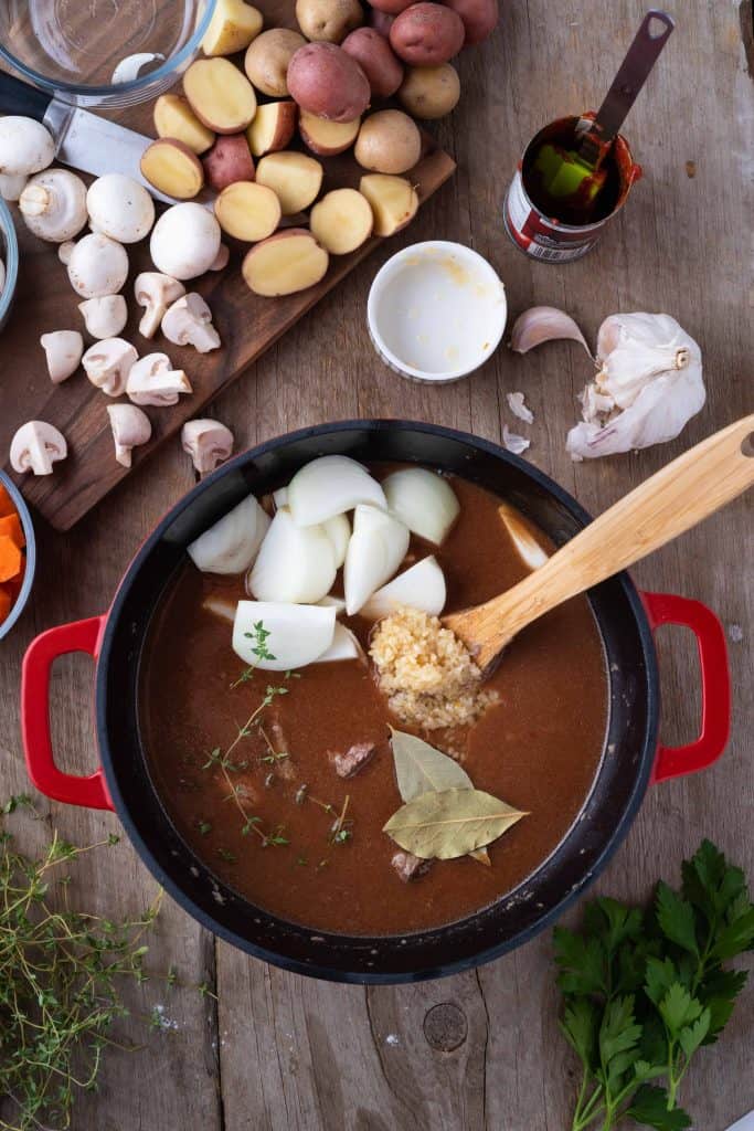 Onions and bay leaves added to beef stew.