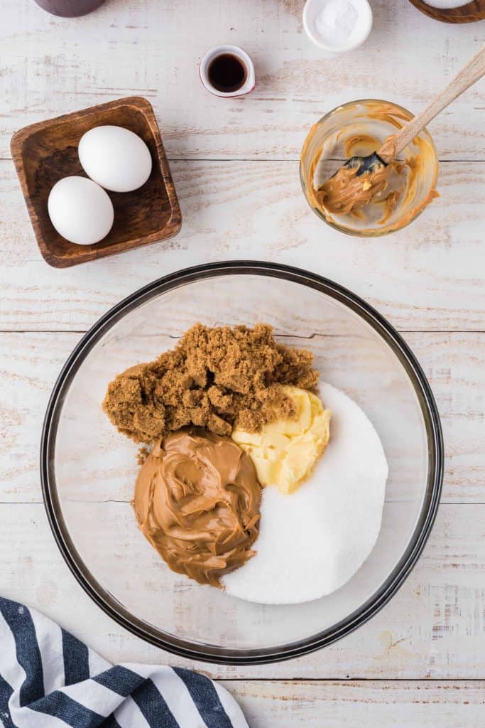 Peanut butter, sugar, butter and brown sugar in a bowl.